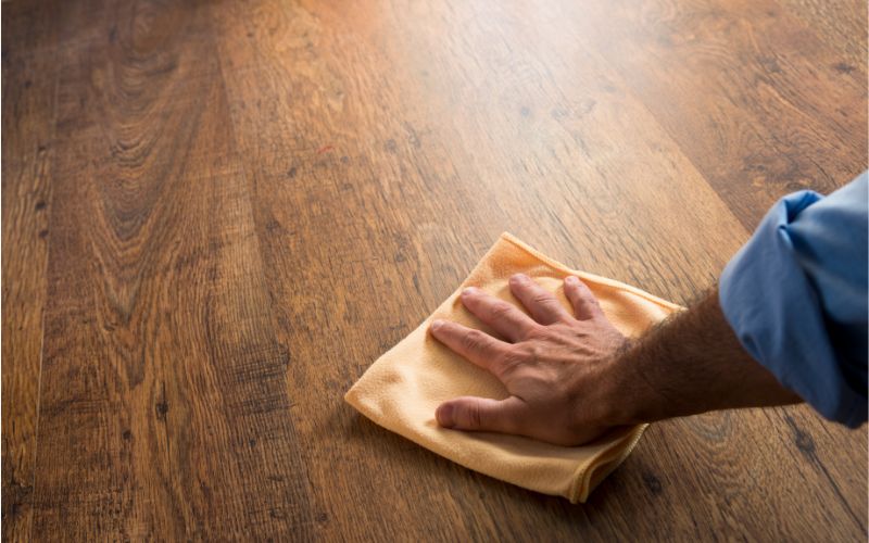 Cleaning hardwood floor by hand.