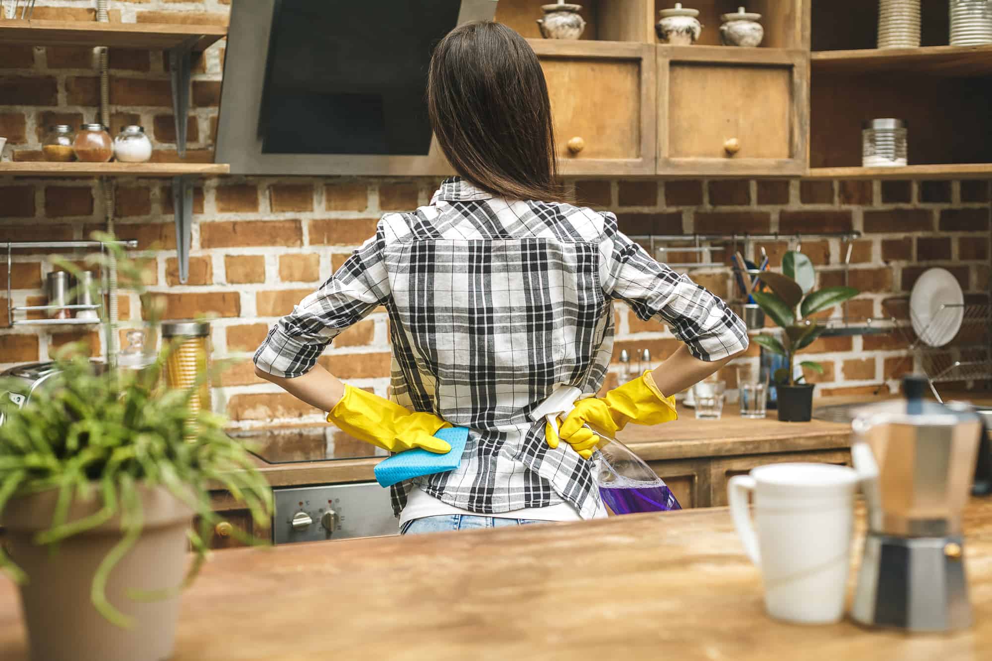 Woman in the kitchen with hands on hips.