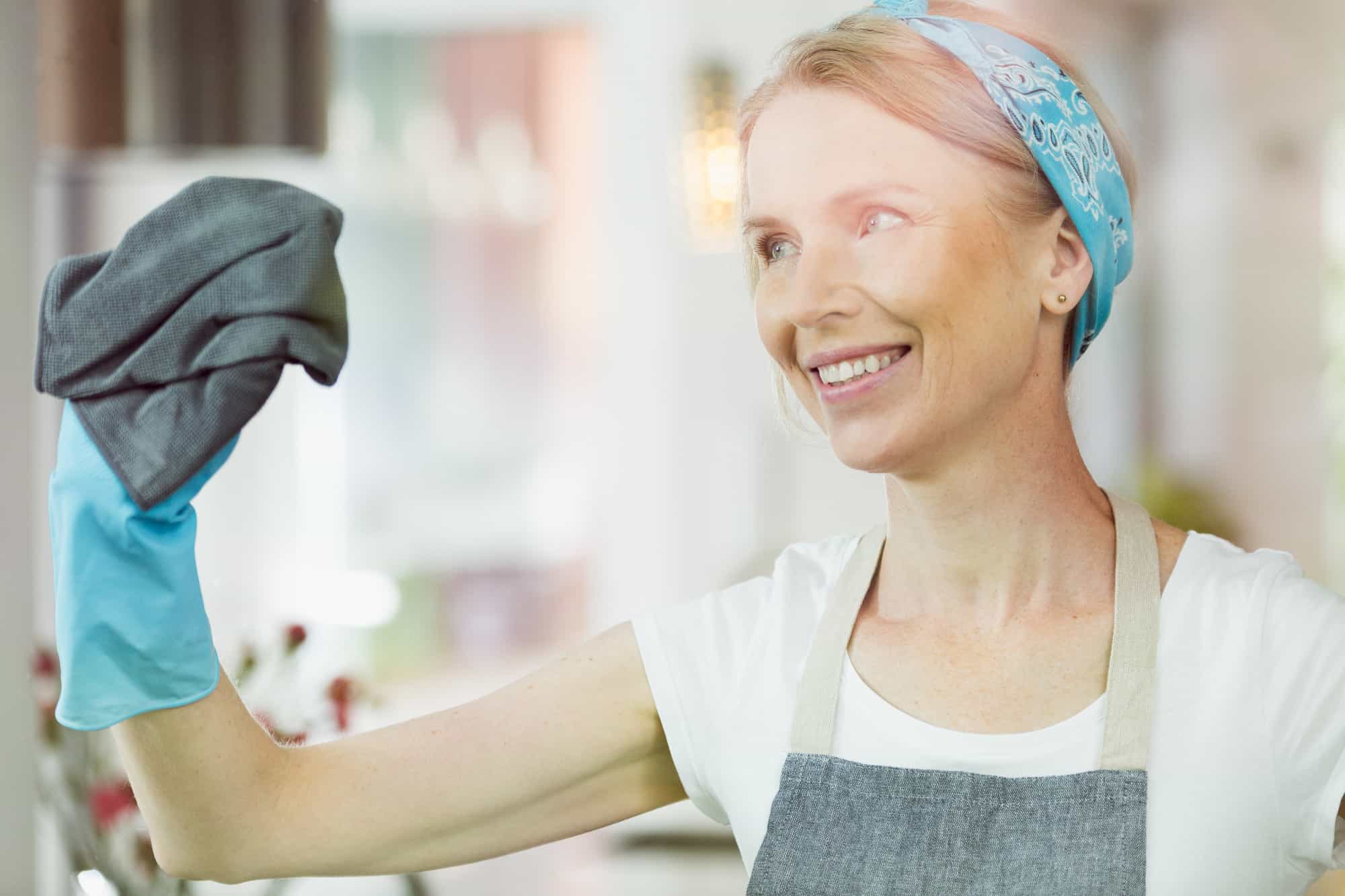 Woman cleaning windows at home.