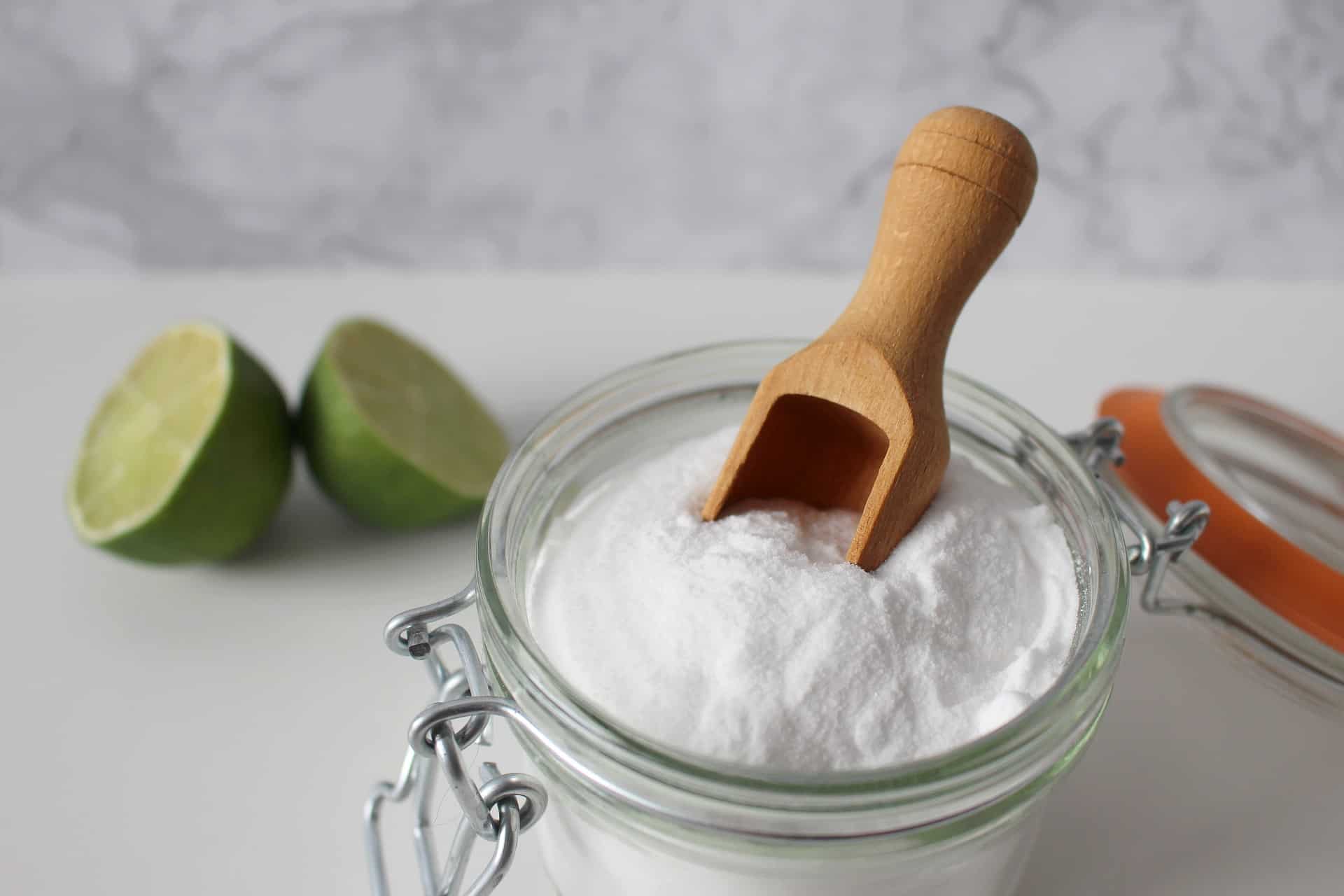 Jar of baking soda and lime halves.