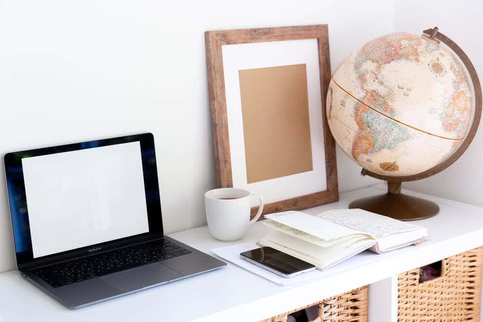 Clean table with laptop and book.