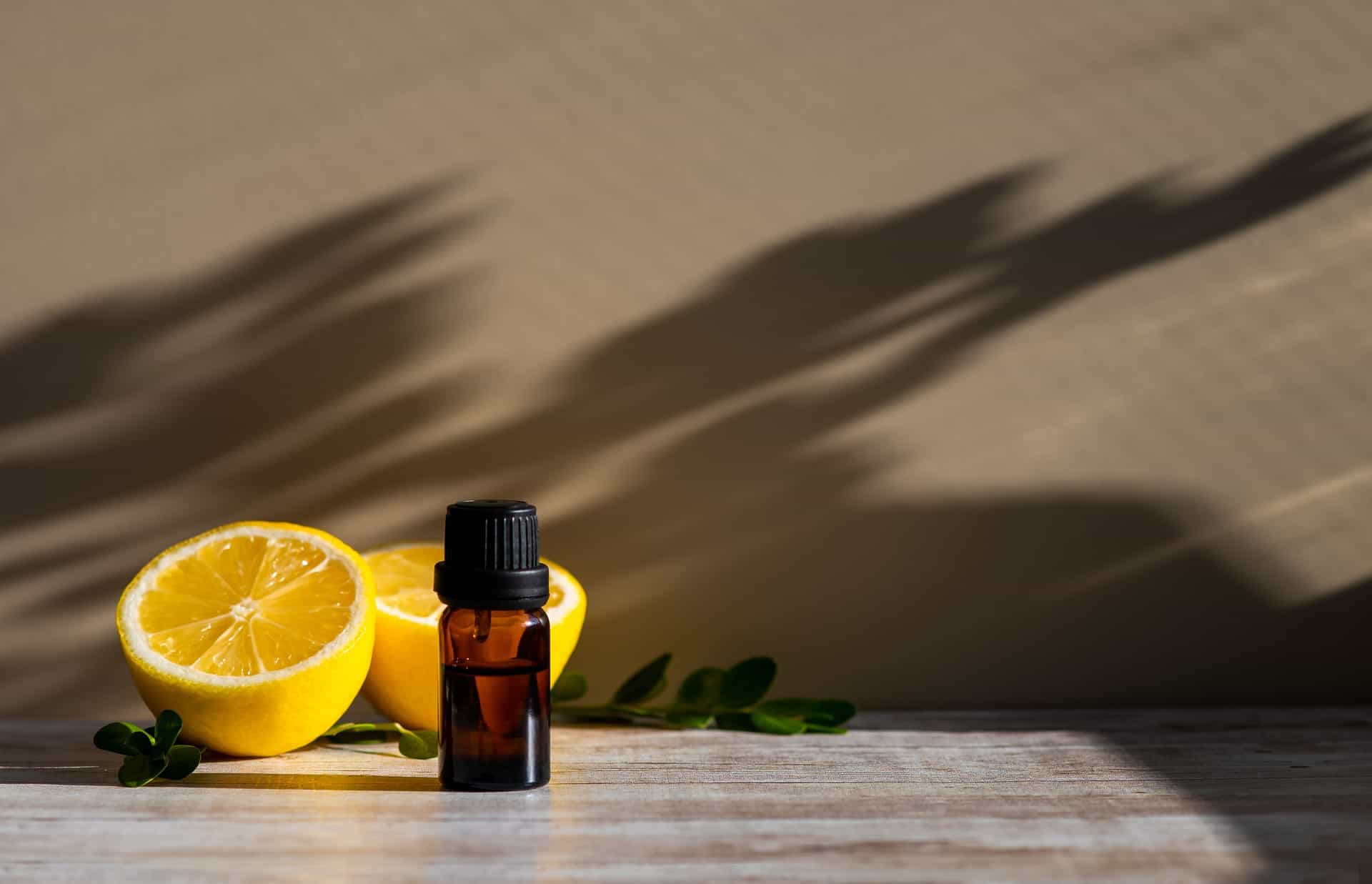 Essential oil bottle with lemon halves.