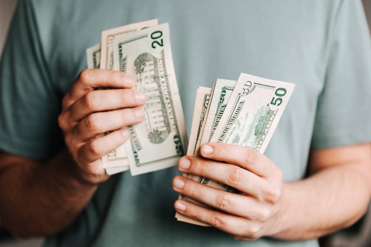 Man counting dollar bills.