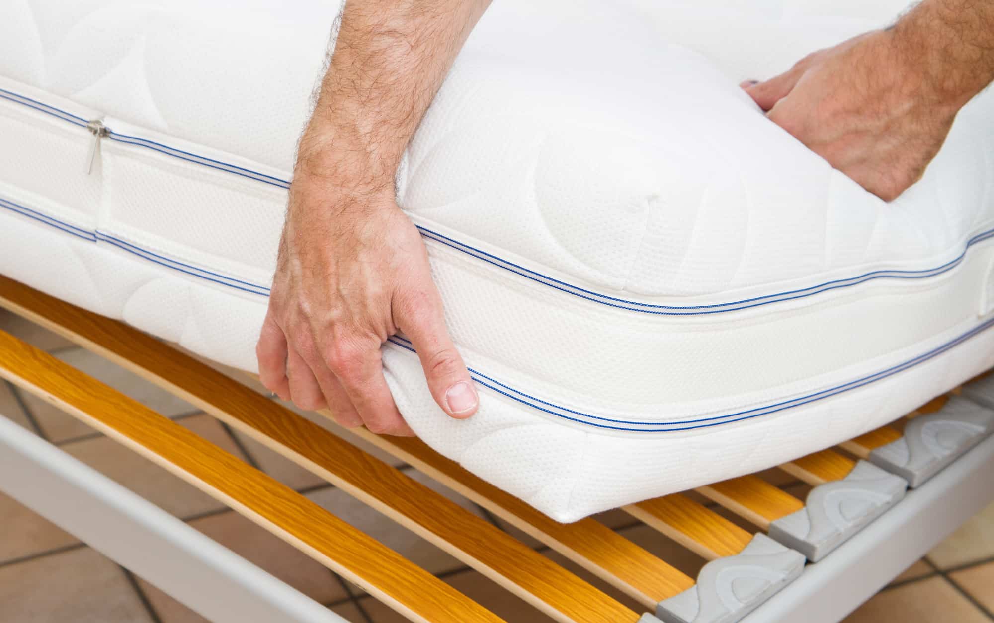 Man demonstrating quality of mattress