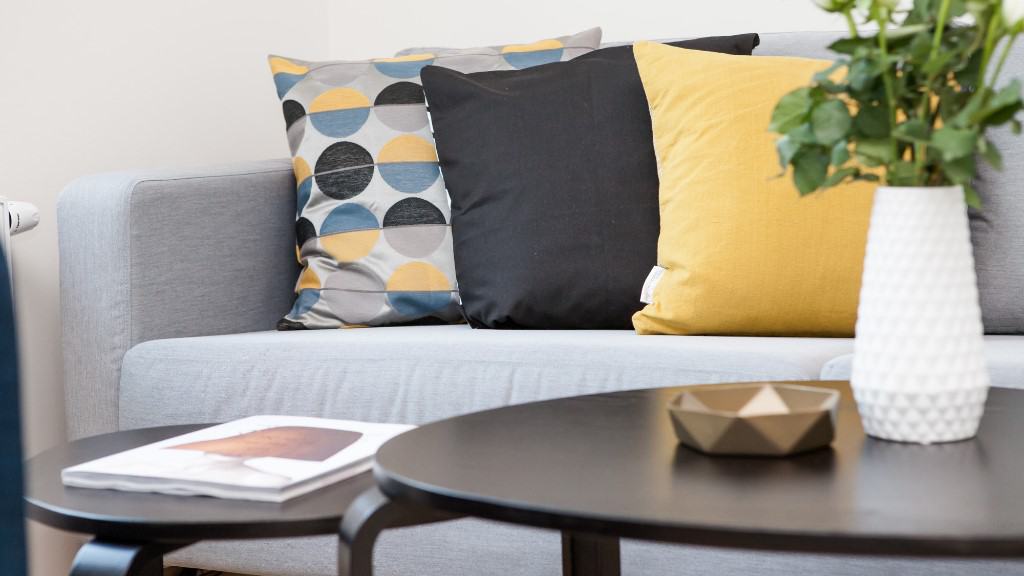 Modern sofa with throw pillows behind cocktail table.