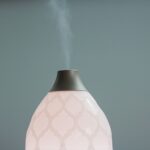 Pink diffuser spraying air freshener.