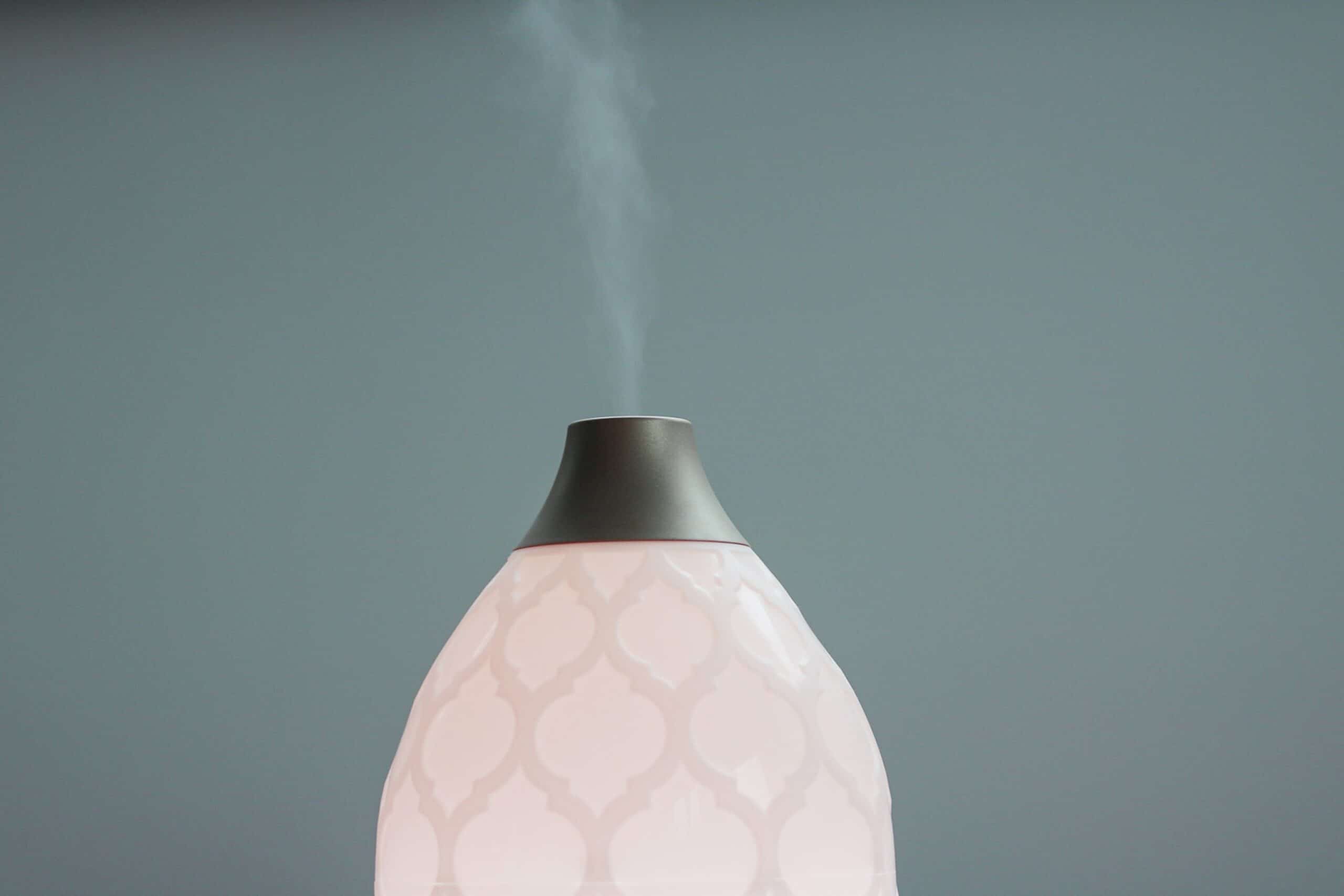 Pink diffuser spraying air freshener.