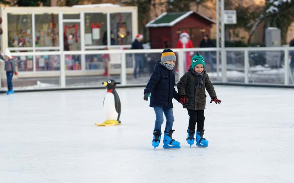 Boy and girl skating together.