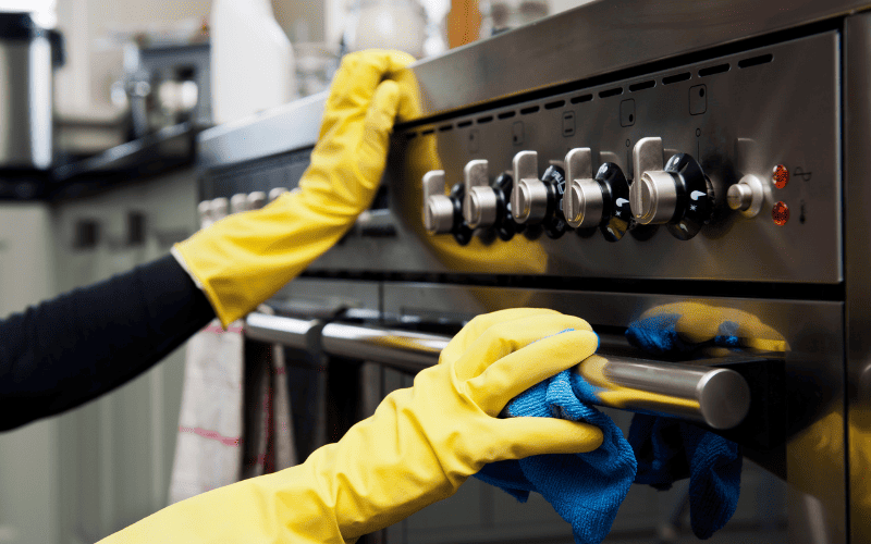 A professional cleaning crew using eco-friendly products for move in cleaning San Diego in a kitchen.